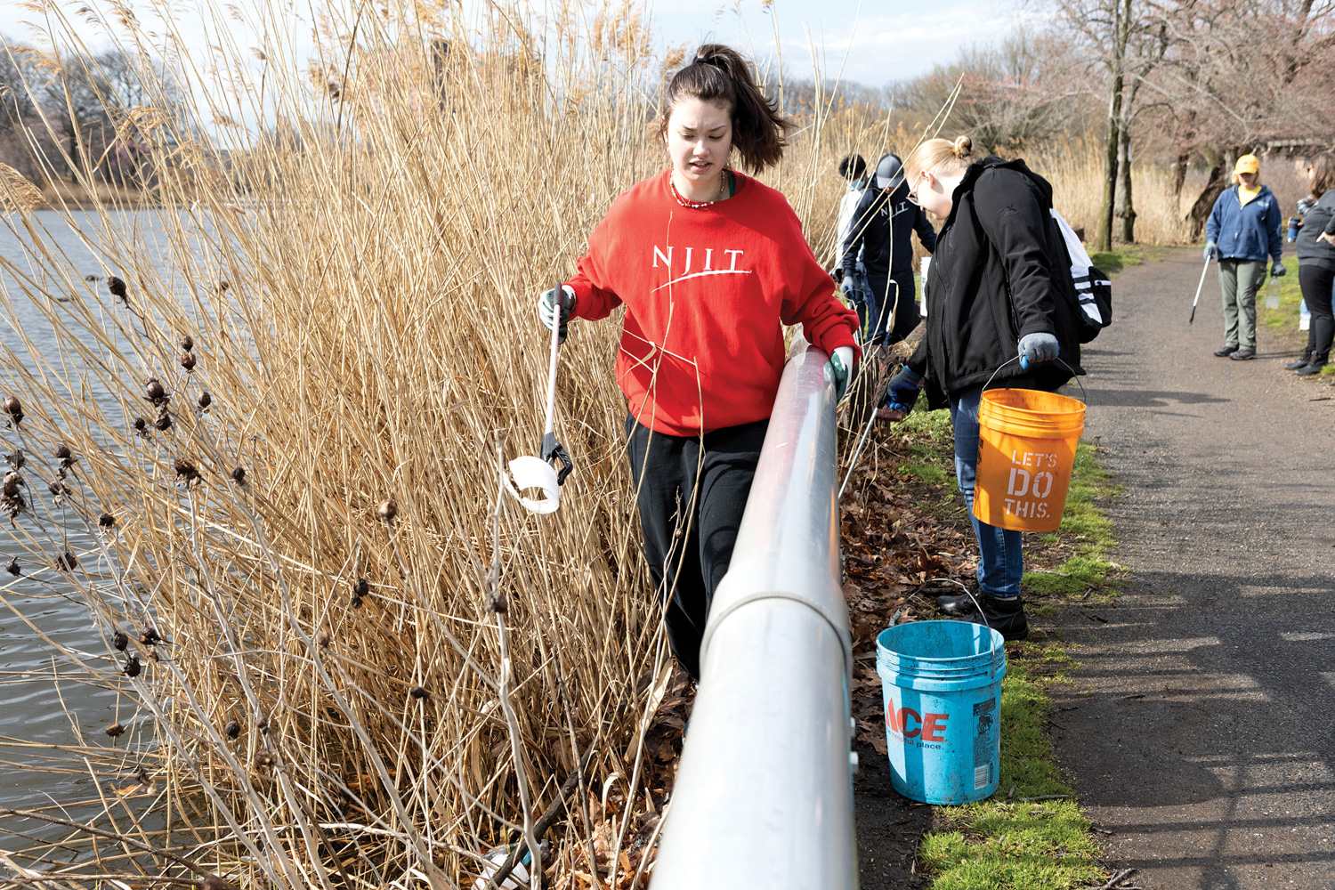 Student volunteers help clean up Branch Brook Park in Newark.