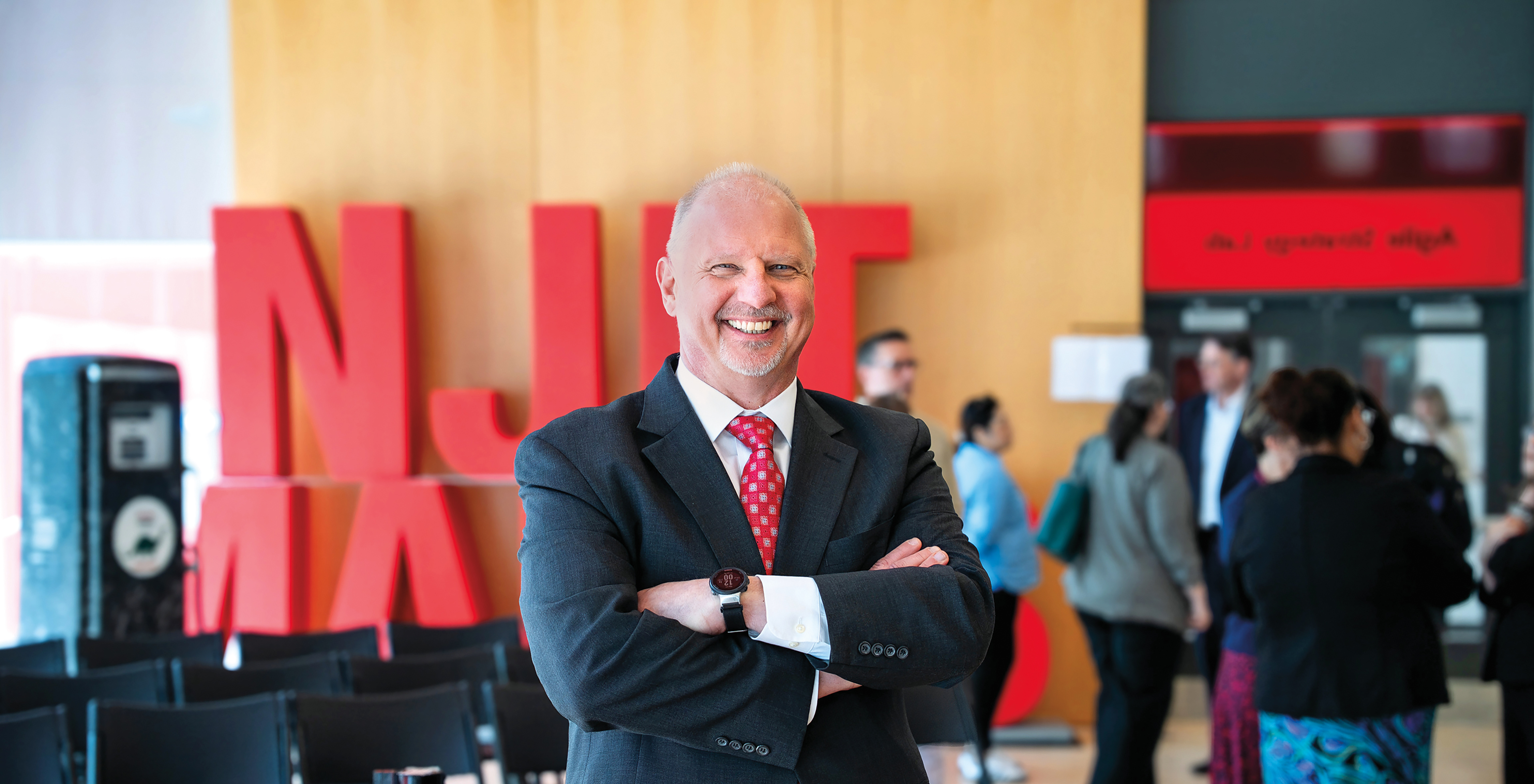 Interim President, John Pelesko, standing in front of the large NJIT Makes sign