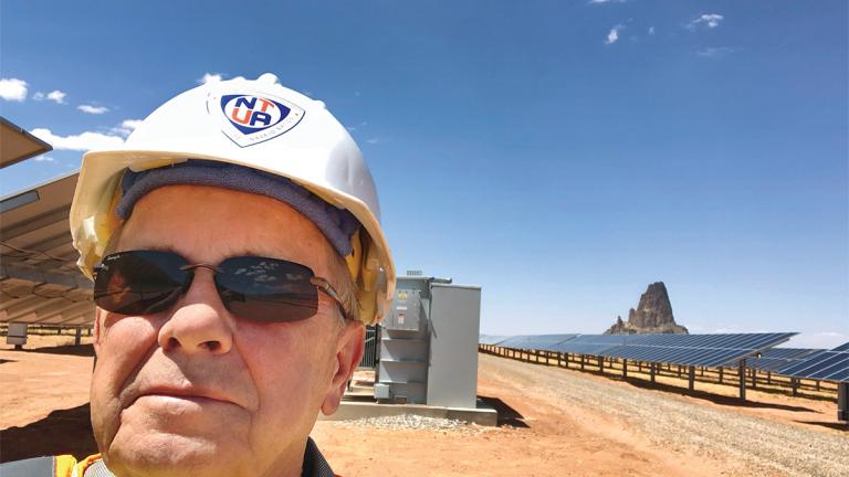 NJIT Alum Glenn Steiger in a solar panel field