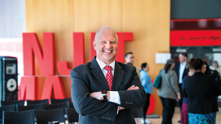 Interim President, John Pelesko, standing in front of the large NJIT Makes sign