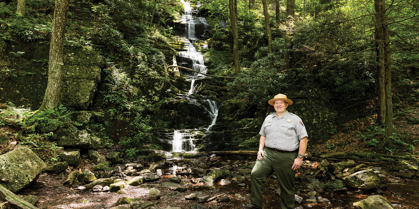 Eamon Leightly standing in front of a cascading waterfall in the Delaware Water Gap