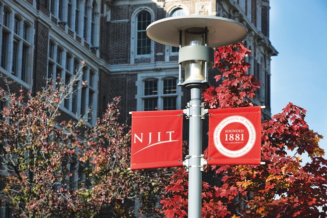 NJIT banners on a campus lamp post