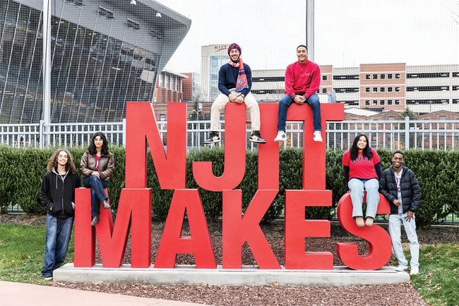 NJIT students with the large NJIT MAKES sign