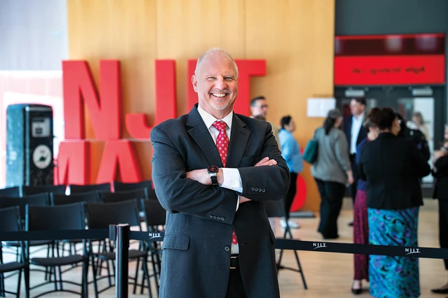 Interim President, John Pelesko, standing in front of the large NJIT Makes sign